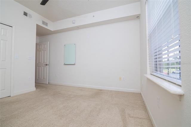 carpeted spare room featuring a textured ceiling