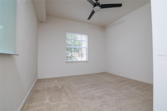 empty room featuring ceiling fan and light colored carpet