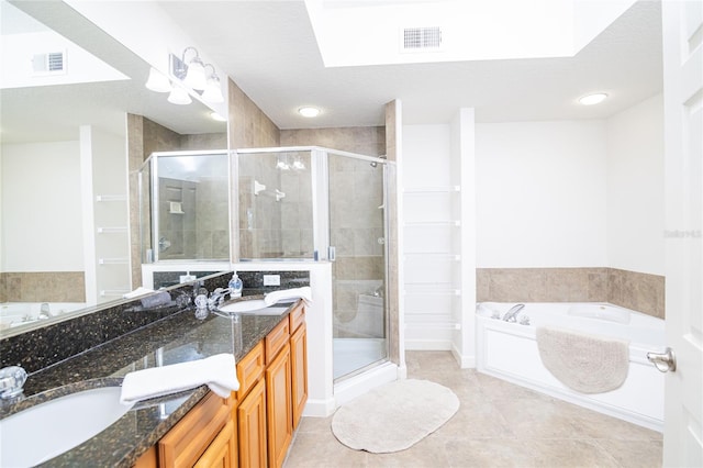 bathroom featuring tile patterned flooring, a textured ceiling, vanity, and separate shower and tub