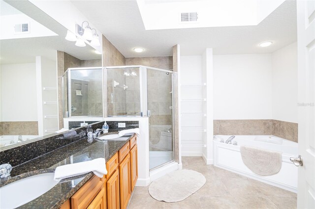4177 N Orange Blossom Trl Unit 210, Orlando, FL 32804 - bathroom with a shower stall, tile patterned floors, double vanity, and a garden tub