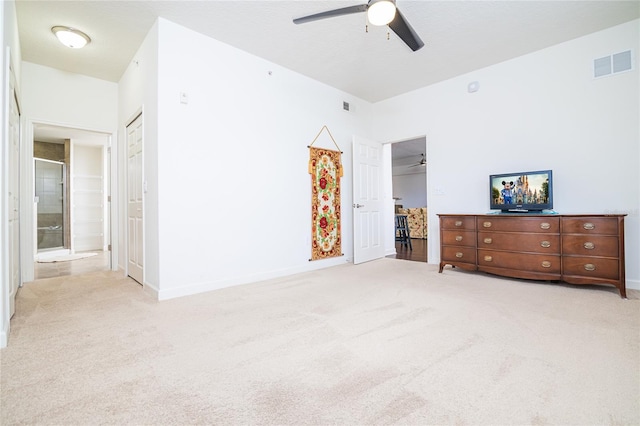 4177 N Orange Blossom Trl Unit 210, Orlando, FL 32804 - bedroom featuring light carpet, baseboards, connected bathroom, and a ceiling fan