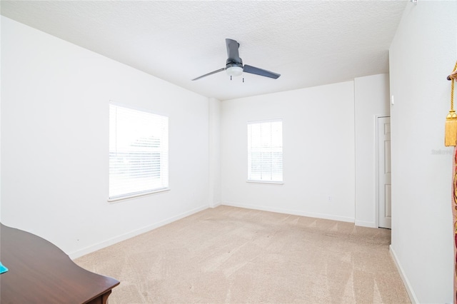 4177 N Orange Blossom Trl Unit 210, Orlando, FL 32804 - unfurnished room featuring light carpet, a ceiling fan, baseboards, and a textured ceiling