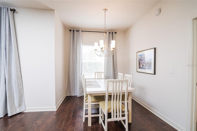 unfurnished dining area with a notable chandelier and dark hardwood / wood-style flooring