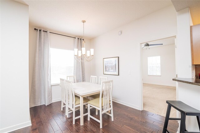 4177 N Orange Blossom Trl Unit 210, Orlando, FL 32804 - dining area featuring a chandelier, dark wood finished floors, and baseboards