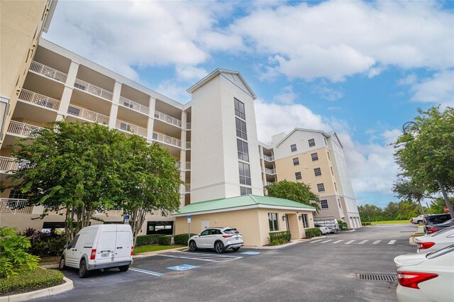 4177 N Orange Blossom Trl Unit 210, Orlando, FL 32804 - view of apartment building / complex featuring uncovered parking