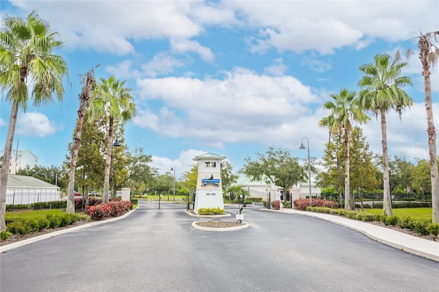 4177 N Orange Blossom Trl Unit 210, Orlando, FL 32804 - view of asphalt street featuring street lights, a gate, curbs, a gated entry, and sidewalks