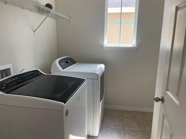 washroom featuring separate washer and dryer and light tile patterned flooring