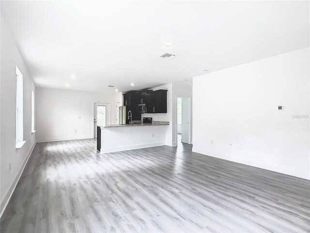 unfurnished living room with dark wood-type flooring