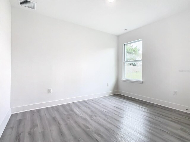 unfurnished room with hardwood / wood-style floors