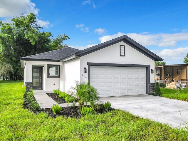 view of front of house with a garage and a front yard