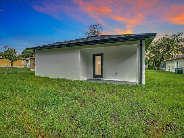 exterior space featuring a yard and cooling unit