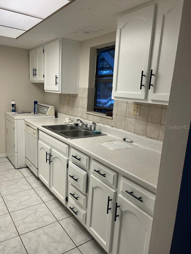 kitchen featuring dishwasher, light tile patterned floors, backsplash, sink, and white cabinetry