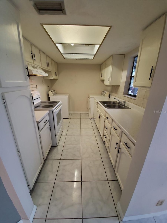 kitchen featuring washer and clothes dryer, electric stove, light tile patterned floors, sink, and white cabinets