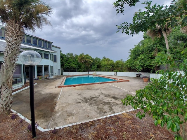 view of swimming pool featuring a patio area