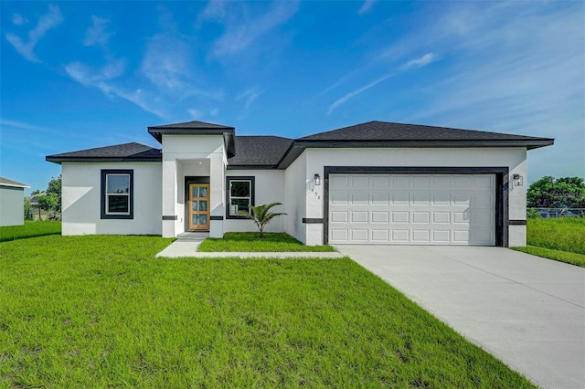 prairie-style house featuring a garage and a front yard