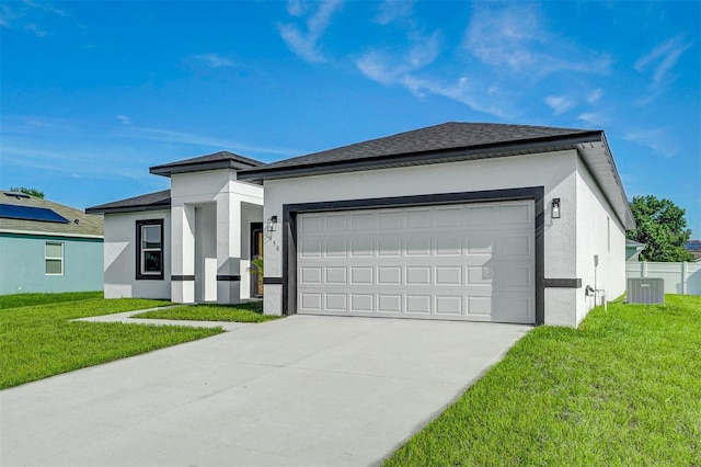 view of front facade with a garage, a front yard, and central air condition unit