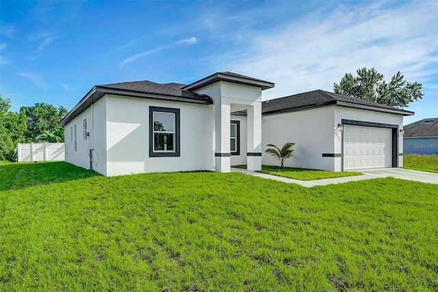 prairie-style house with a garage and a front lawn