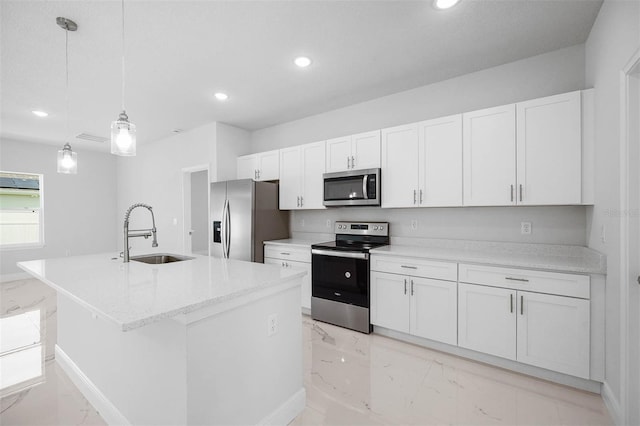 kitchen with pendant lighting, sink, white cabinetry, a kitchen island with sink, and stainless steel appliances