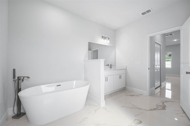 bathroom featuring a washtub and vanity