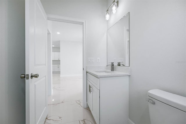 bathroom with toilet and vanity