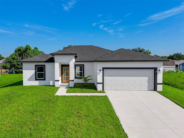 prairie-style house with a garage and a front lawn