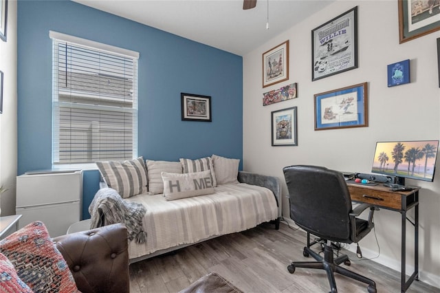 bedroom with light hardwood / wood-style floors and ceiling fan