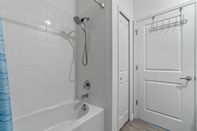 bathroom featuring shower / bathtub combination with curtain and hardwood / wood-style flooring