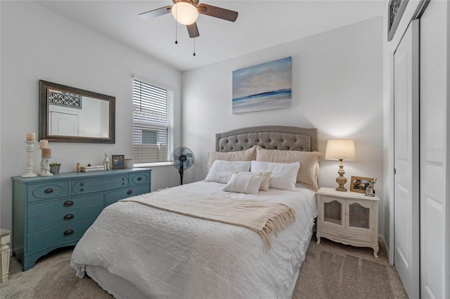 carpeted bedroom with ceiling fan and a closet