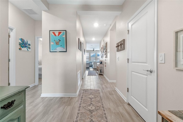 hallway with light hardwood / wood-style flooring