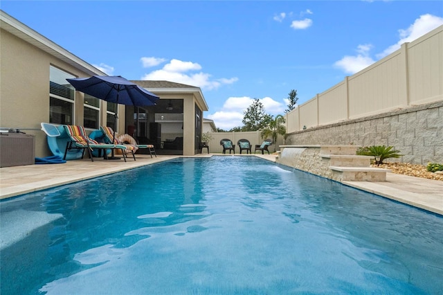 view of pool with pool water feature and a patio area