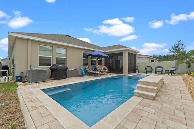 view of swimming pool with a patio, area for grilling, and central air condition unit