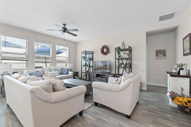 living room featuring ceiling fan and hardwood / wood-style flooring