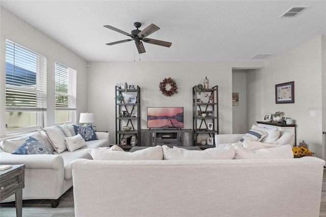 living room with wood-type flooring and ceiling fan