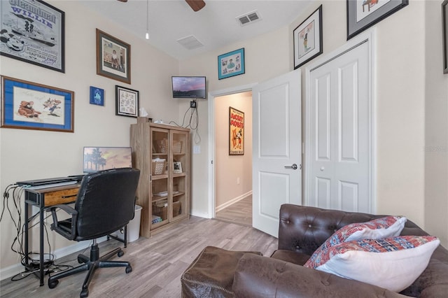 office with ceiling fan and light hardwood / wood-style flooring