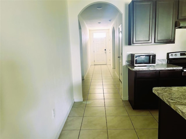 corridor featuring light tile patterned floors