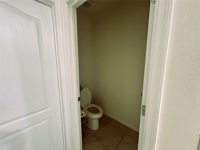 bathroom with tile patterned flooring and toilet