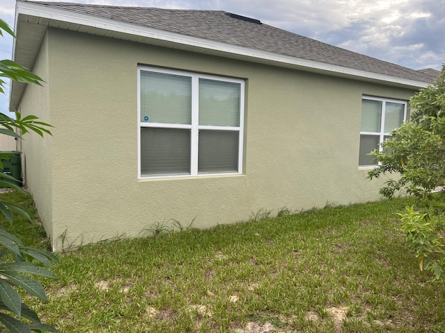 view of home's exterior with a lawn