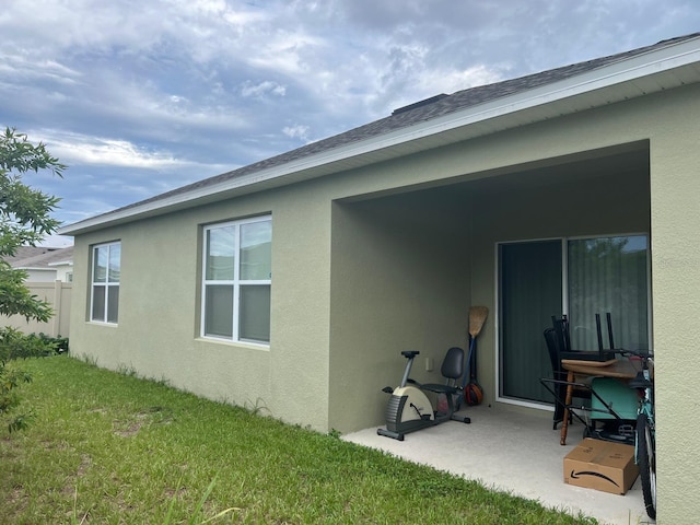 rear view of property with a patio and a yard