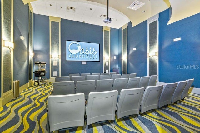 carpeted cinema with a towering ceiling