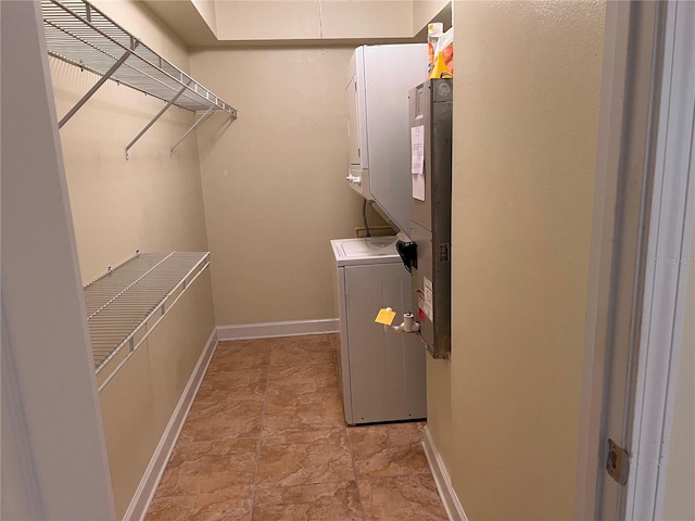 clothes washing area with cabinets