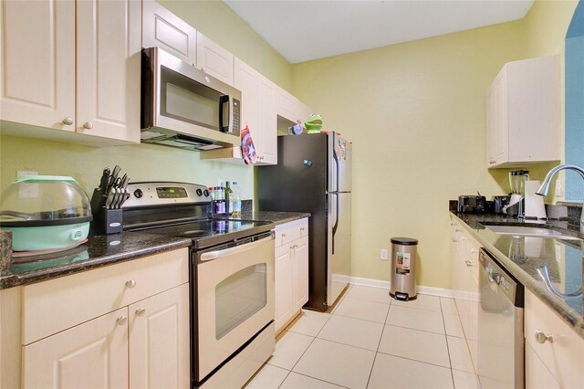 kitchen featuring white cabinets, appliances with stainless steel finishes, and sink