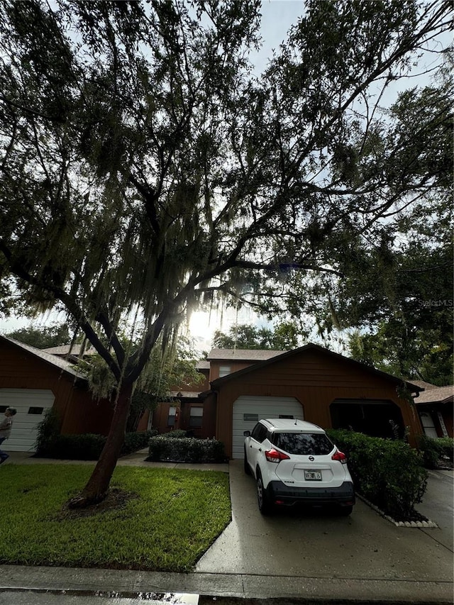 ranch-style house featuring a garage and a front lawn