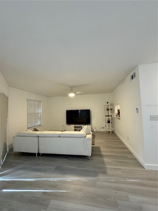 unfurnished living room with ceiling fan and hardwood / wood-style flooring