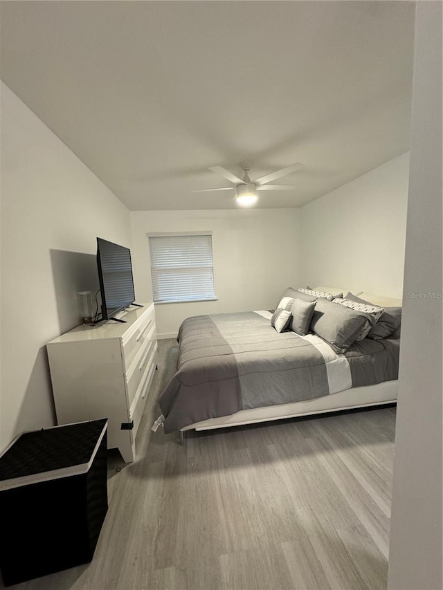 bedroom with ceiling fan and light hardwood / wood-style flooring