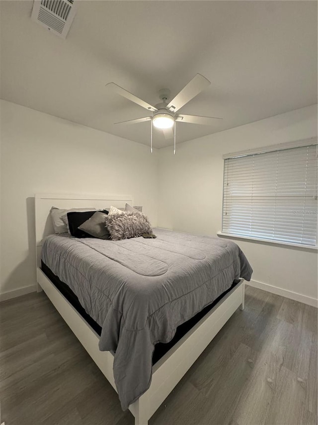 bedroom featuring ceiling fan and dark hardwood / wood-style floors