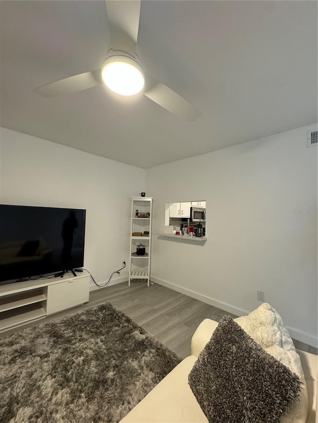 interior space with ceiling fan and hardwood / wood-style flooring