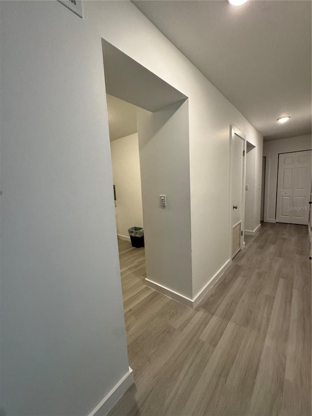 hallway with light wood-type flooring