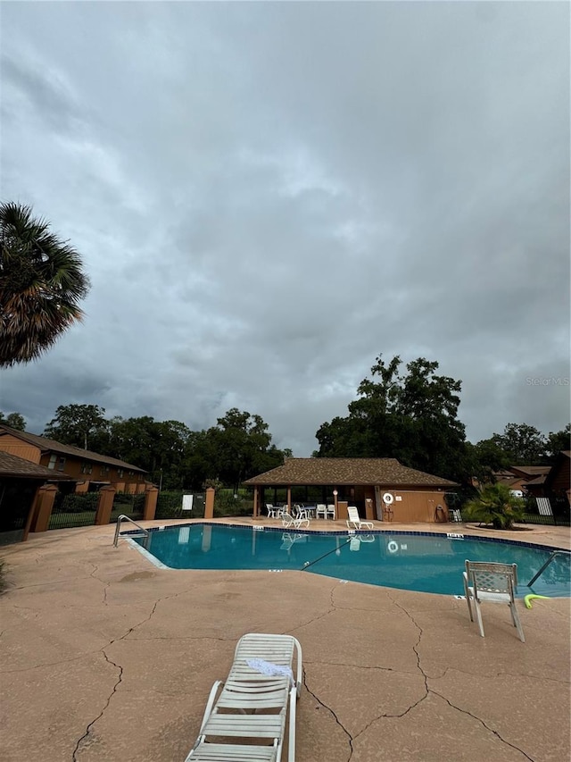 view of swimming pool featuring a patio area