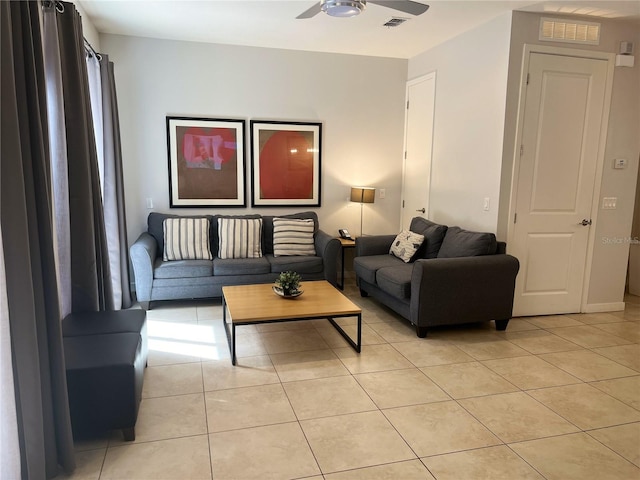 living room with ceiling fan and light tile patterned flooring