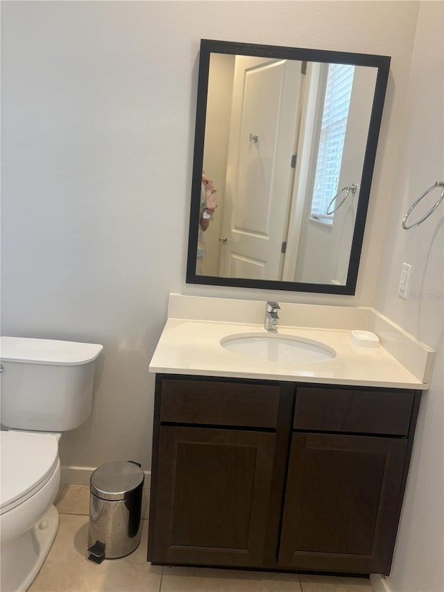 bathroom with tile patterned floors, vanity, and toilet